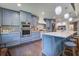 Spacious kitchen with custom cabinets, barstool seating, stainless steel appliances, and hardwood floors at 408 N Palmetto St, Summerville, SC 29483