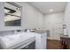 Spacious laundry room with updated machines, hardwood floors, window, and plenty of room at 408 N Palmetto St, Summerville, SC 29483