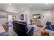 Open-concept living room featuring a stylish rug, vaulted ceilings, and plenty of natural light at 408 N Palmetto St, Summerville, SC 29483