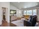 Bright living room with hardwood floors, large windows, comfortable seating, and stylish decor at 408 N Palmetto St, Summerville, SC 29483