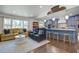 Open-concept living room and kitchen with hardwood floors, modern lighting, and stylish furnishings at 408 N Palmetto St, Summerville, SC 29483