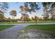 Street view in the community with manicured lawns, mature trees and single Gathering homes at 408 N Palmetto St, Summerville, SC 29483