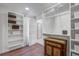 Bright walk-in closet with custom shelving, wood floors, and charming antique cabinet for organized storage solutions at 408 N Palmetto St, Summerville, SC 29483