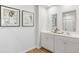Modern bathroom featuring dual vanities, wood-look floors, and artwork at 415 Mistflower Ln, Moncks Corner, SC 29461