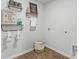Well-organized laundry room with decorative shelving and vinyl flooring at 415 Mistflower Ln, Moncks Corner, SC 29461