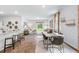 Open-concept living and dining area featuring hardwood floors and a large window for natural light at 415 Mistflower Ln, Moncks Corner, SC 29461