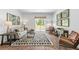 Comfortable living room with a neutral color scheme, patterned rug, and plenty of natural light from the sliding doors at 415 Mistflower Ln, Moncks Corner, SC 29461