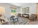 Inviting living room featuring a cozy sofa, unique artwork, and sliding doors that lead to outdoor space at 415 Mistflower Ln, Moncks Corner, SC 29461