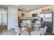 Modern kitchen equipped with stainless steel appliances, white cabinetry, and a dining area with seating for four at 416 Mistflower Ln, Moncks Corner, SC 29461