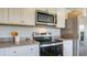 Well-equipped kitchen featuring stainless steel appliances, ample counter space, and white cabinetry for modern cooking at 416 Mistflower Ln, Moncks Corner, SC 29461
