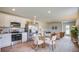 Open kitchen features stainless steel appliances, white cabinets, and flows into a dining area and living room at 416 Mistflower Ln, Moncks Corner, SC 29461