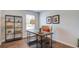Bright office featuring stylish desk, modern shelving, hardwood floors, and comfortable armchair at 416 Mistflower Ln, Moncks Corner, SC 29461