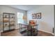 Well-lit home office featuring a modern desk, decorative shelving, and comfortable seating at 416 Mistflower Ln, Moncks Corner, SC 29461