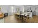 Open-concept kitchen and dining area featuring modern lighting, stainless appliances, and bar seating at 421 Mistflower Ln, Moncks Corner, SC 29461