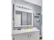 Bright bathroom featuring a marble vanity top, light gray walls, and decorative shelving at 4662 Nibbs Ln, North Charleston, SC 29418