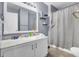 Bright bathroom featuring a marble vanity top, light gray walls, and a shower with a patterned curtain at 4662 Nibbs Ln, North Charleston, SC 29418