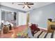 Bedroom with wood floors, blue walls, a closet, and large windows for natural light at 4662 Nibbs Ln, North Charleston, SC 29418