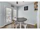 Bright dining area with a round table, pendant lighting, and access to a backyard patio at 4662 Nibbs Ln, North Charleston, SC 29418