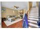 Inviting living room with hardwood floors, a cozy fireplace, and stairway access to the upper level at 4662 Nibbs Ln, North Charleston, SC 29418