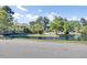 Scenic pond with a bridge, lush trees, and landscaping in a serene community setting at 4662 Nibbs Ln, North Charleston, SC 29418