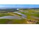 Aerial view of river, marsh, and bridge with winding waterways through green landscape at 4943 Green Dolphin Way, Kiawah Island, SC 29455