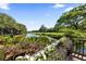Picturesque backyard with lush landscaping, a pond, and golf course views at 4943 Green Dolphin Way, Kiawah Island, SC 29455