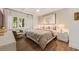 This elegant bedroom offers beautiful hardwood floors and a large decorative print above the bed at 4943 Green Dolphin Way, Kiawah Island, SC 29455