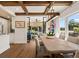Well-lit dining room boasts wooden table, contemporary lighting, and backyard view through large windows at 4943 Green Dolphin Way, Kiawah Island, SC 29455