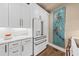Bright kitchen features modern white cabinetry, bronze hardware and stainless steel appliances at 4943 Green Dolphin Way, Kiawah Island, SC 29455