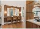 Bright kitchen boasts a breakfast bar with stylish pendant lighting and wood slat accent wall at 4943 Green Dolphin Way, Kiawah Island, SC 29455