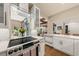 A modern kitchen featuring white cabinets, stainless appliances, and a view through to living spaces at 4943 Green Dolphin Way, Kiawah Island, SC 29455