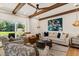 Comfortable living room with wood beam ceilings and access to a backyard patio at 4943 Green Dolphin Way, Kiawah Island, SC 29455