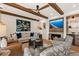 Living room featuring a fireplace, custom entertainment center, and wood beam ceiling at 4943 Green Dolphin Way, Kiawah Island, SC 29455