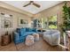 Comfortable sun room featuring a blue sofa, rattan furniture, and an inviting view at 4943 Green Dolphin Way, Kiawah Island, SC 29455