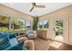 Bright sun room with large windows, cozy seating, and scenic views of the outdoors at 4943 Green Dolphin Way, Kiawah Island, SC 29455