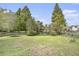 Spacious backyard with play equipment and a view of the pond at 4987 Ballantine Dr, Summerville, SC 29485