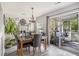 Bright dining area with a stylish table, modern chandelier, and access to the screened porch at 4987 Ballantine Dr, Summerville, SC 29485