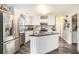 Bright kitchen with stainless steel appliances, center island, and white cabinetry at 4987 Ballantine Dr, Summerville, SC 29485