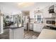 Modern kitchen featuring stainless steel appliances, island, and an open view to the dining area at 4987 Ballantine Dr, Summerville, SC 29485