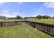 Grassy backyard with wooden fence, ideal for outdoor enjoyment and privacy at 5040 Thornton Dr, Summerville, SC 29485