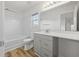 Bathroom featuring wood-look floors, gray vanity and a shower-tub combo at 5040 Thornton Dr, Summerville, SC 29485
