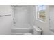 A bright and clean bathroom featuring a tub with shower and a window at 5040 Thornton Dr, Summerville, SC 29485