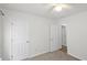 Bright bedroom featuring neutral carpet, white walls, and a ceiling fan for added comfort at 5040 Thornton Dr, Summerville, SC 29485