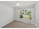 Cozy bedroom with a large window offering natural light and views of the outside landscape at 5040 Thornton Dr, Summerville, SC 29485