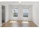 Bright dining area with hardwood floors, large windows, and a serene view, creating a cozy atmosphere at 5040 Thornton Dr, Summerville, SC 29485