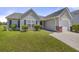 Charming single-story home with a well-maintained lawn, siding, and an attached one-car garage at 5040 Thornton Dr, Summerville, SC 29485