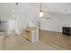 Bright kitchen shows view into a living room with fireplace and wood flooring at 5040 Thornton Dr, Summerville, SC 29485