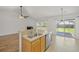 Open kitchen view shows a breakfast bar leading to a well-lit living space at 5040 Thornton Dr, Summerville, SC 29485