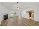 Bright living room features vaulted ceilings, a fireplace, and wood floors at 5040 Thornton Dr, Summerville, SC 29485