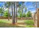 Large backyard with mature trees and wooden fence at 523 Kilarney Rd, Summerville, SC 29483